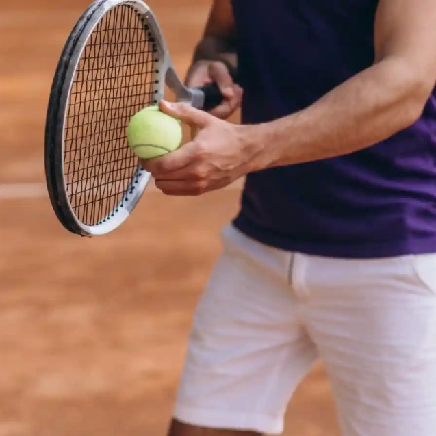 young-man-tennis-player-court-tennis-racket-close-up1-1600x900